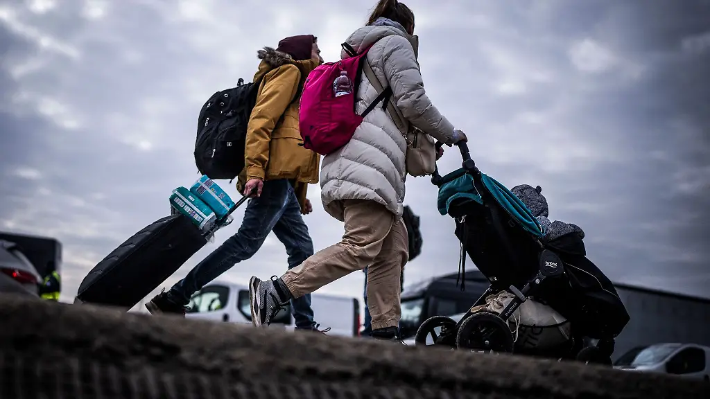 Gefluechtete-Ukrainer-gehen-nach-ihrem-Grenzuebertritt-von-Schehyni-in-der-Ukraine-nach-Medyka