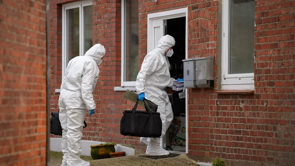 Ermittler-der-Polizei-betreten-in-Spurensicherungs-Anzuegen-die-Wohnung-des-mutmasslichen-Tatorts