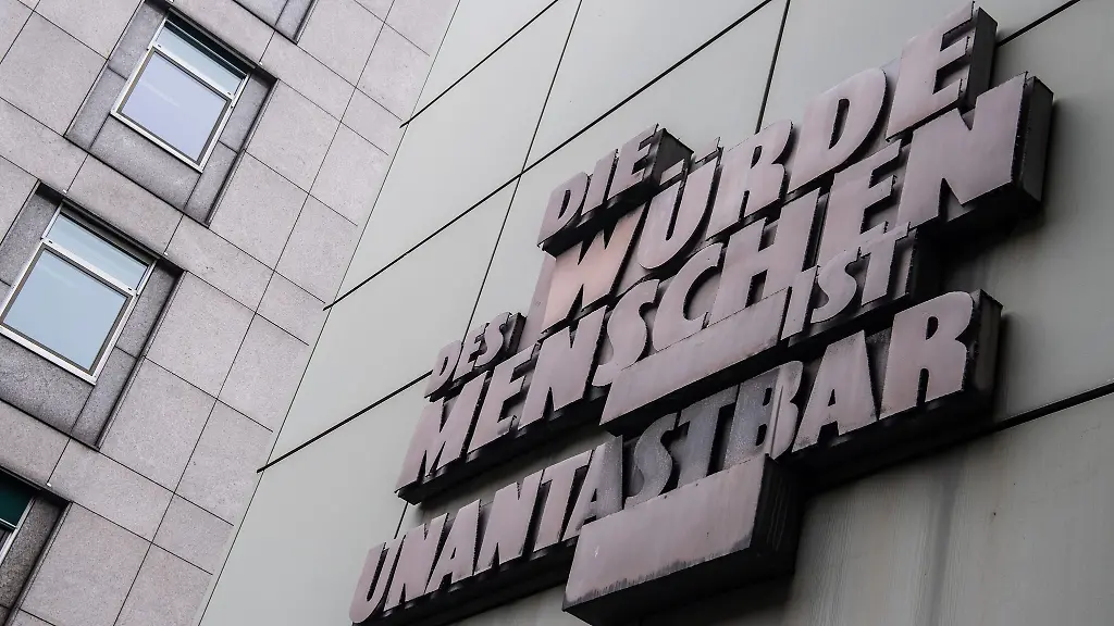 Die-Wuerde-des-Menschen-ist-unantastbar-steht-an-der-Fassade-des-Landgerichts-in-Frankfurt-am-Main