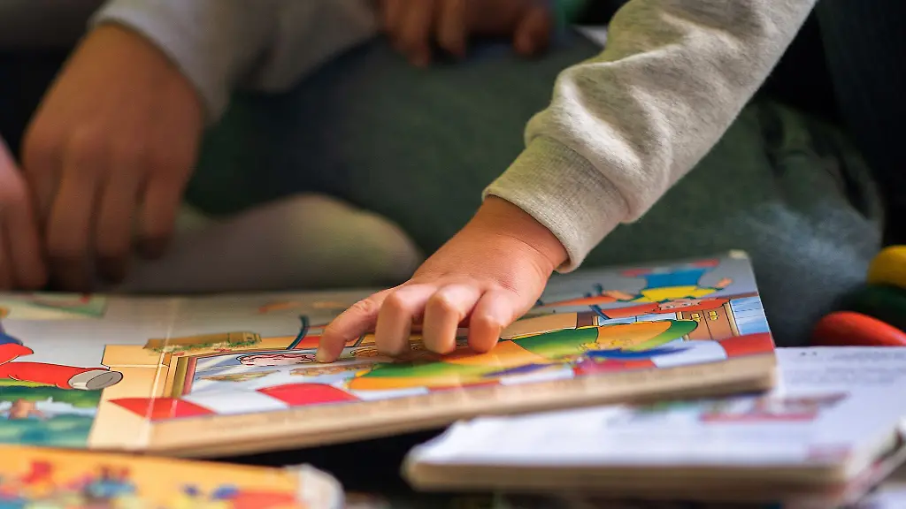 Eine-Praktikantin-liest-in-einer-Kita-Kindern-vor