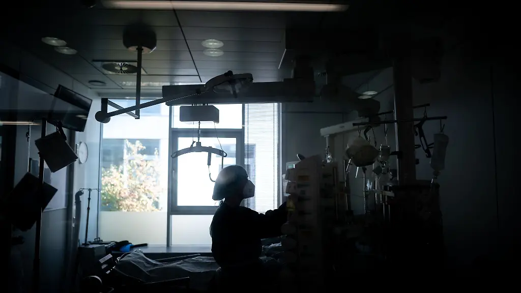 Eine-Mitarbeiterin-der-Pflege-steht-in-einem-Zimmer-einer-Corona-Intensivstation