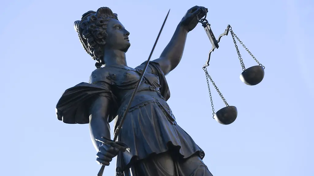 Eine-Statue-der-Justitia-steht-unter-freiem-Himmel