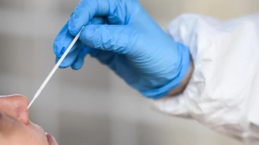 Ein-medizinischer-Mitarbeiter-entnimmt-einer-Frau-fuer-einen-Corona-Test-einen-Abstrich