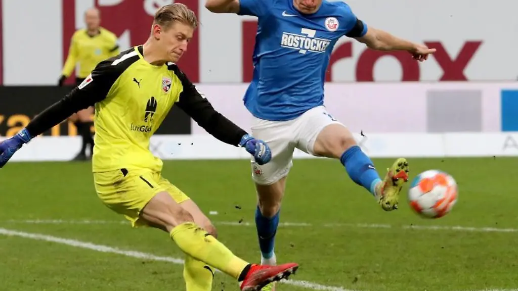 Der-Ingolstaedter-Torwart-Robert-Jendrusch-l-kann-vor-dem-Rostocker-Kevin-Schumacher-klaeren