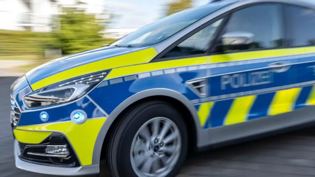 Ein-Polizeiwagen-faehrt-mit-eingeschaltetem-Blaulicht