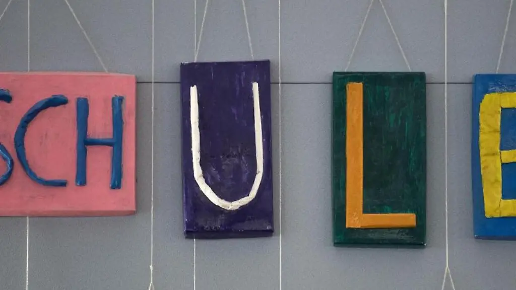 An-einer-Wand-haengt-ein-Schriftzug-Schule