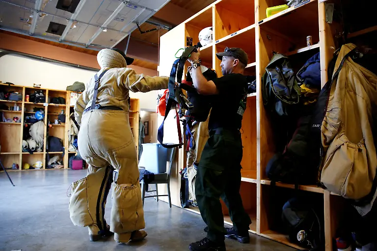 Mark-Duffey-47-helps-Nate-Rose-put-on-safety-gear