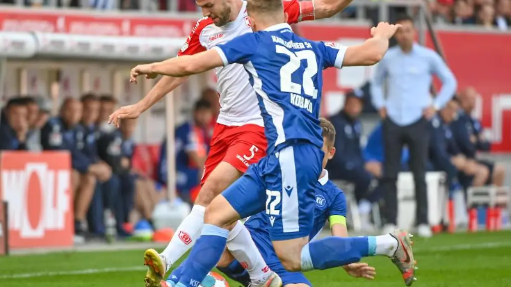 Benedikt-Gimber-von-Regensburg-l-und-Christoph-Kobald-von-Karlsruhe-kaempfen-um-den-Ball