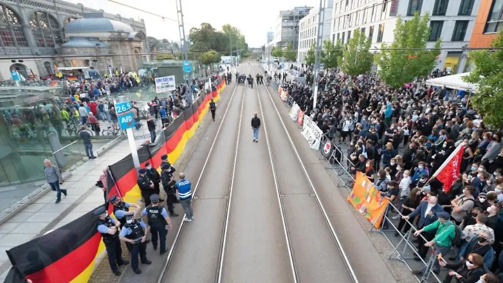Gegendemonstranten-r-stehen-waehrend-einer-Kundgebung-der-islam-und-fremdenfeindlichen-Pegida-Bewegung-l-auf-dem-Wiener-Platz-vor-dem-Hauptbahnhof
