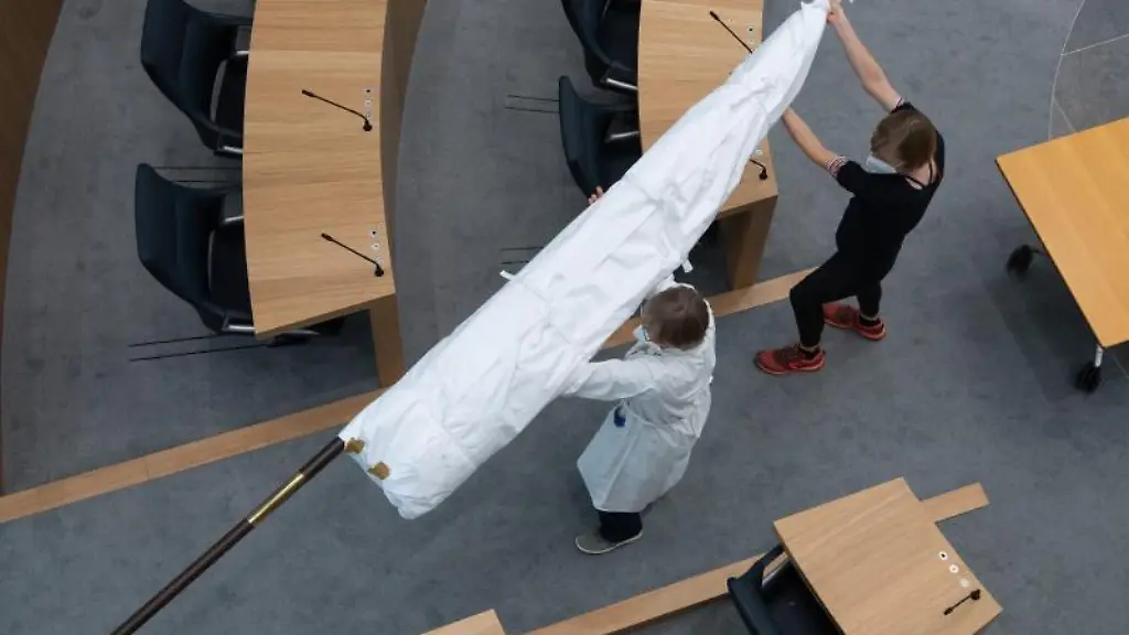 Zwei-Restauratorinnen-tragen-die-historische-Hambacher-Fahne