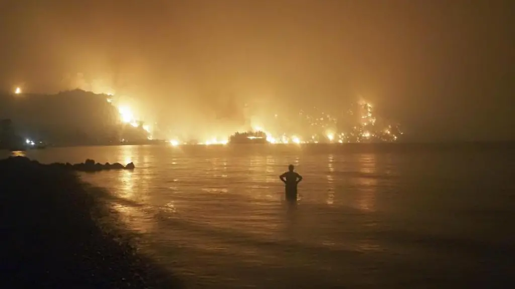 Ein-Mann-beobachtet-die-Flammen-als-sich-ein-Waldbrand-auf-der-Insel-Evia-naehert