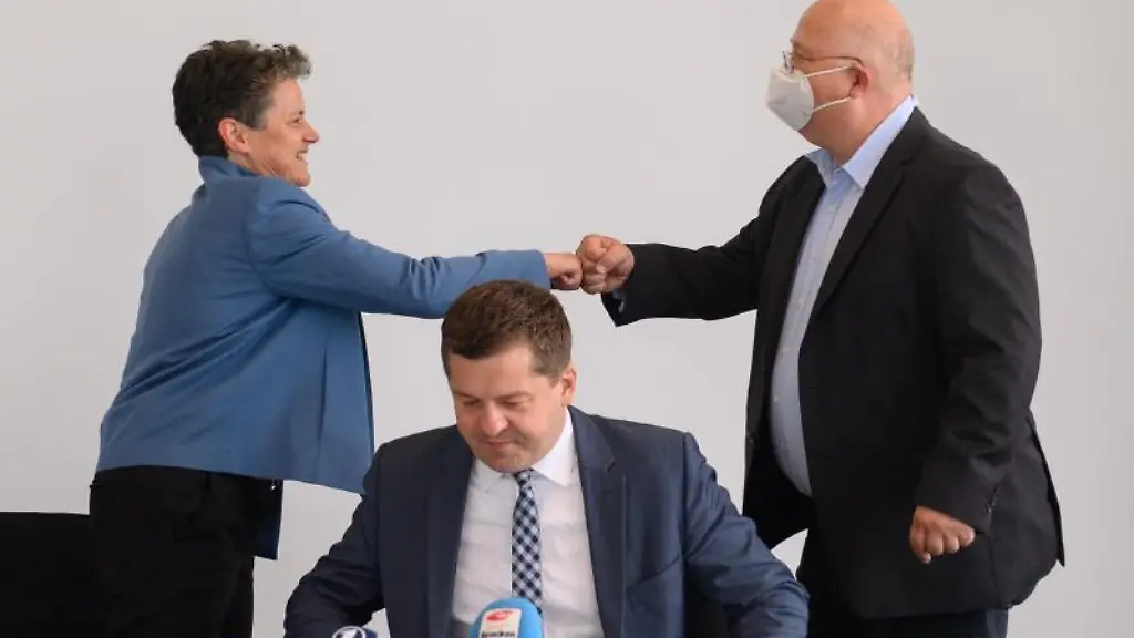 Lydia-Hueskens-FDP-Landesvorsitzende-und-Andreas-Schmidt-r-SPD-Landesvorsitzender-begruessen-sich-hinter-Sven-Schulze-CDU-Landesvorsitzender