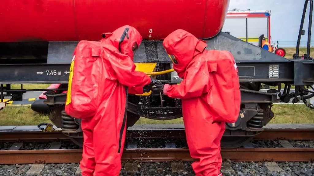 Mitarbeiter-der-Feuerwehr-in-Schutzanzuegen-trainieren-das-Abdichten-eines-Lecks