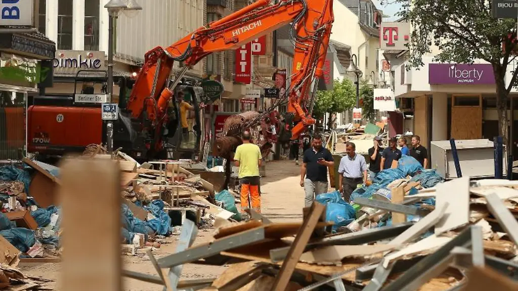Ein-Bagger-verlaedt-Sperrmuell-der-sich-auf-einer-Strasse-in-der-Innenstadt-tuermt