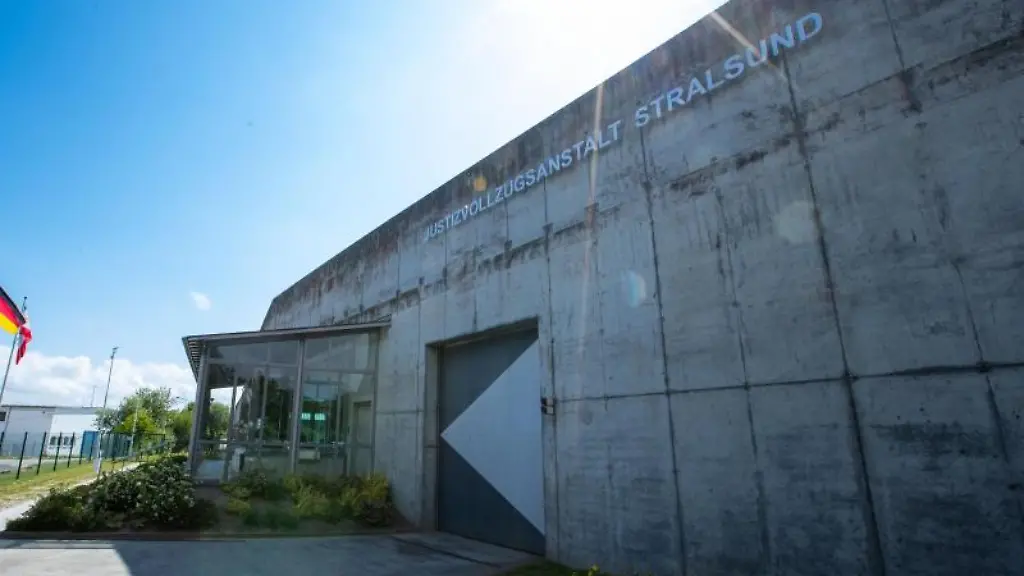 Ein-Eingangsbereich-der-Justizvollzugsanstalt-Stralsund-ist-mit-einer-hohen-Betonmauer-gesichert