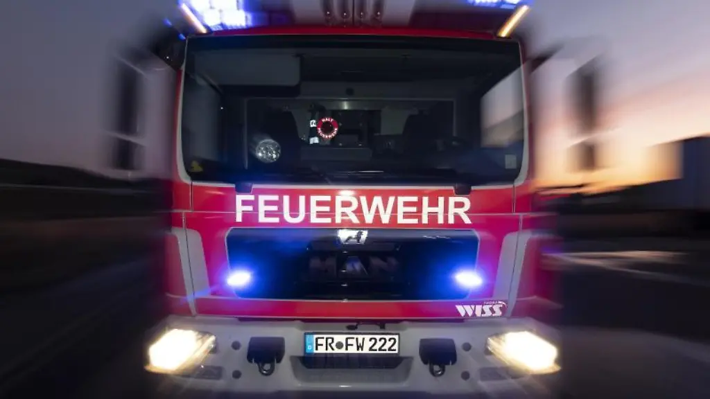 Ein-Feuerwehrfahrzeug-steht-mit-eingeschaltetem-Blaulicht-auf-einer-Strasse