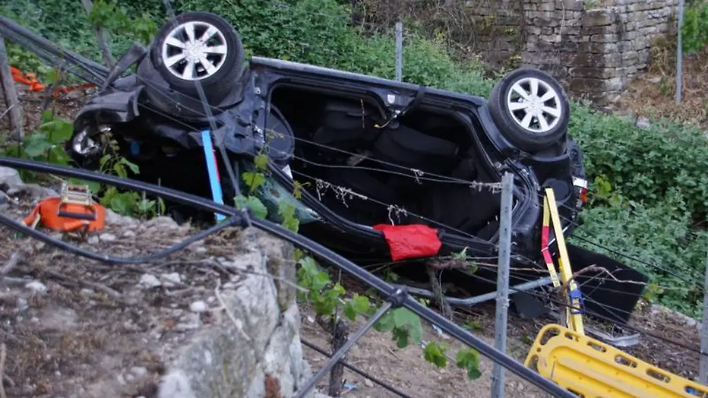 Ein-Auto-liegt-nach-einem-Unfall-in-einem-Steilhang-in-einem-Weinberg