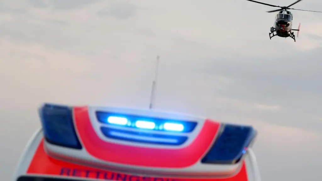 Ein-Hubschrauber-fliegt-ueber-einem-Rettungswagen-zu-einem-Unfallort