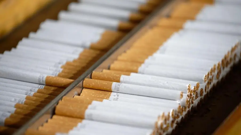 Zigaretten-liegen-bei-einer-Pressekonferenz-der-Zollfahndung-auf-einer-ausgestellten-Maschine-zur-Zigarettenherstellung