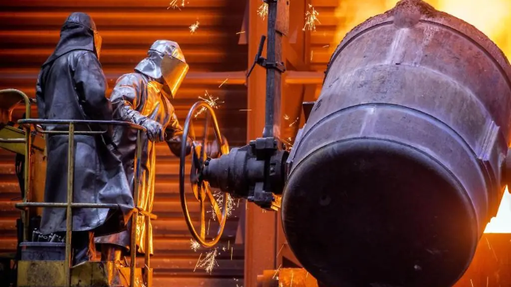 Arbeiter-giessen-fluessiges-Eisen-mit-einer-Temperatur-von-1-400-Grad-in-der-Eisengiesserei-Torgelow-in-vorbereitete-Formen