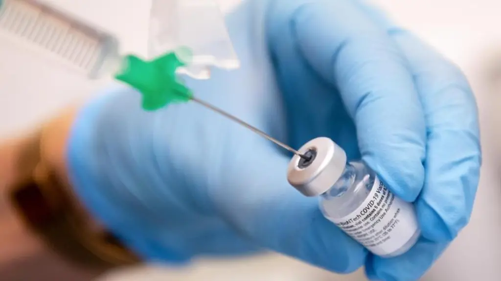 Eine-Klinik-Mitarbeiterin-zieht-den-Covid-19-Impfstoff-von-Biontech-Pfizer-fuer-eine-Impfung-auf-eine-Spritze