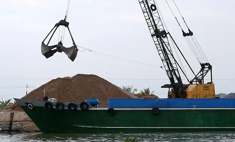 A-crane-moves-sand-from-a-ship-on-Mekong-river-in-Hau-Giang-province-Vietnam-December-19-2018-Picture-taken-December-19-2018