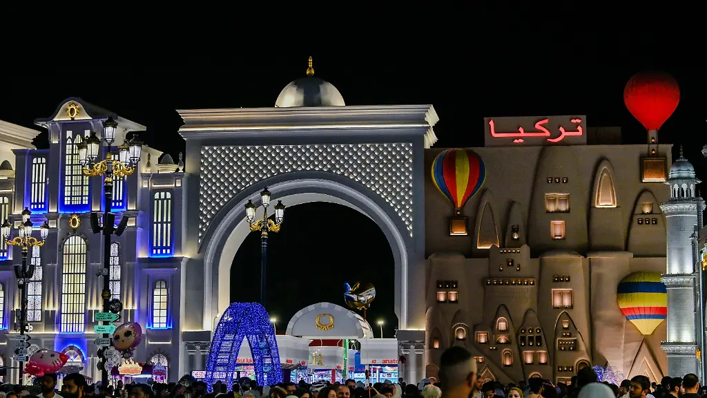 DUBAI-UNITED-ARAB-EMIRATES-APRIL-12-People-enjoy-during-tourism-leisure-shopping-and-entertainment-project-Global-Village-combining-cultures-of-countries-across-the-world-at-one-place-in-Dubai-United-Arab-Emirates-on-April-12-2024-The-village-hosts-more-than-5-million-visitors-every-year-on-an-area-of-approximately-1-600-000-mA