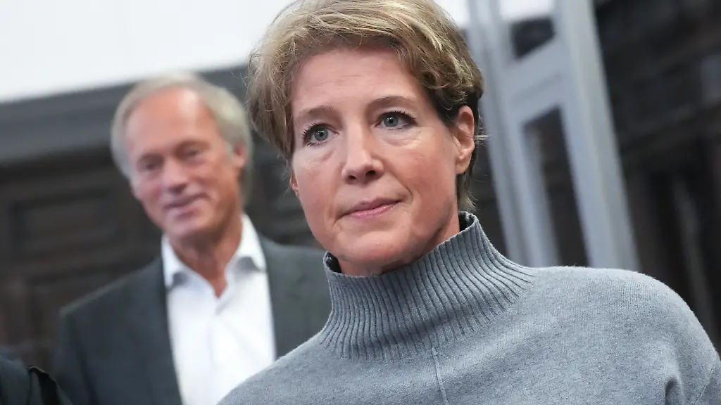 Christina-Block-r-deutsche-Gastronomin-und-Unternehmerin-steht-vor-Gerhard-Delling-ehemaliger-Fernsehmoderator-und-Sportjournalist-zu-Beginn-des-Prozesses-wegen-mutmasslicher-Kindesentfuehrung-im-Sitzungssaal-im-Landgericht-Hamburg-In-einer-Nacht-und-Nebel-Aktion-waren-in-der-Silvesternacht-2023-24-zwei-Kinder-der-Gastronomie-Unternehmerin-Block-von-Daenemark-nach-Deutschland-gebracht-worden-Wegen-der-mutmasslichen-Entfuehrung-findet-am-Landgericht-Hamburg-der-Prozess-statt-unter-anderem-gegen-Block