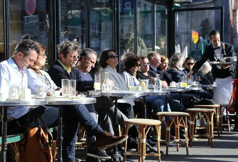 Parisians-and-tourists-fill-a-terrace-of-a-cafe-in-Paris-on-November-15-2015-Major-monuments-are-shuttered-and-security-enhanced-two-days-after-the-city-was-struck-by-a-series-of-coordinated-attacks-that-claimed-at-least-120-lives-including-many-who-were-dining-on-cafe-terraces-The-Islamic-State-ISIS-has-claimed-responsibility-for-the-attacks