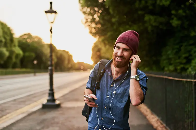 Travel-walking-and-portrait-of-man-in-city-for-music-streaming-subscription-and-online-radio-Urban-town-happy-and-person-on-smartphone-with-earphones-for-listening-to-song-audio-and-podcast-Travel-walking-and-portrait-of-man-in-city-for-music-streaming-subscription-and-online-radio-Urban-town-happy-and-person-on-smartphone-with-earphones-for-listening-to-song-audio-and-podcast-model-released-61773786
