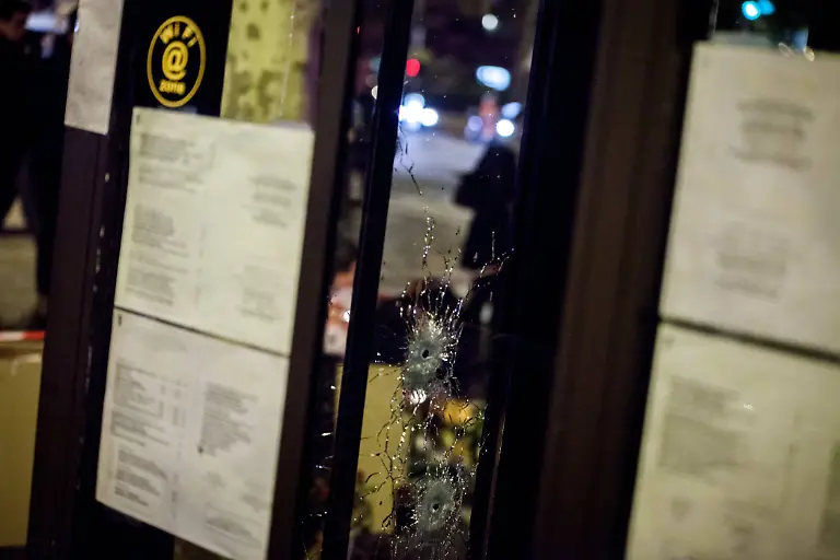 Bullet-impact-in-the-front-of-the-cafe-la-bonne-biere-Following-the-Paris-attacks-all-night-long-many-people-came-to-light-candles-place-words-or-flowers-on-the-Place-de-la-Republique-Rue-Bichat-or-Faubourg-du-Temple-November-15-2015-Paris-France-The-official-death-toll-of-these-Islamist-terrorist-attacks-shows-130-dead-and-413-wounded-hospitalized-November-15-2015-Paris-France