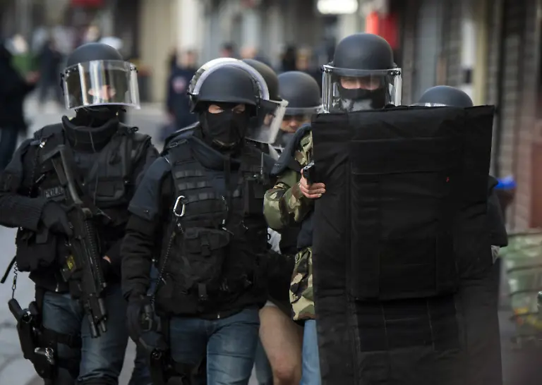 This-handout-picture-dated-November-18-2015-shows-the-French-police-special-forces-during-a-raid-on-an-apartment-in-Saint-Denis-north-of-Paris-The-operation-was-aimed-at-capturing-suspected-mastermind-of-the-Paris-attacks-Belgian-Abdelhamid-Abaaoud-Five-were-arrested-and-three-died-among-which-was-Abaaoud