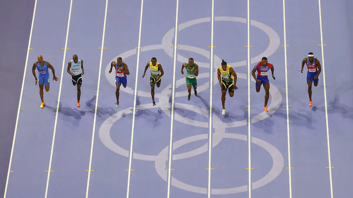 Paris-Olympics-Athletics-Noah-Lyles-3rd-from-L-of-the-United-States-runs-en-route-to-winning-the-men-s-100-meter-final-at-the-Paris-Olympics-on-Aug-4-2024-at-Stade-de-France-in-Saint-Denis-near-Paris