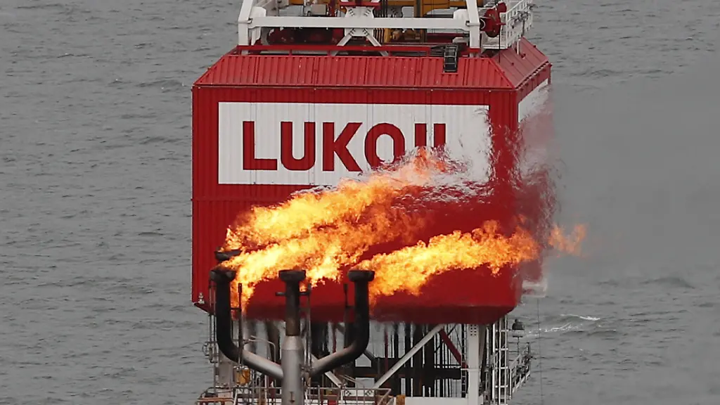 FILE-PHOTO-A gas torch-seen-next-to-the-company-Lukoil-sign-on-the-filanovskogo-oil-platform-in-the-Caspian-Sea-of-Russia-16-October-2018-Picture-taken-16-October-2018
