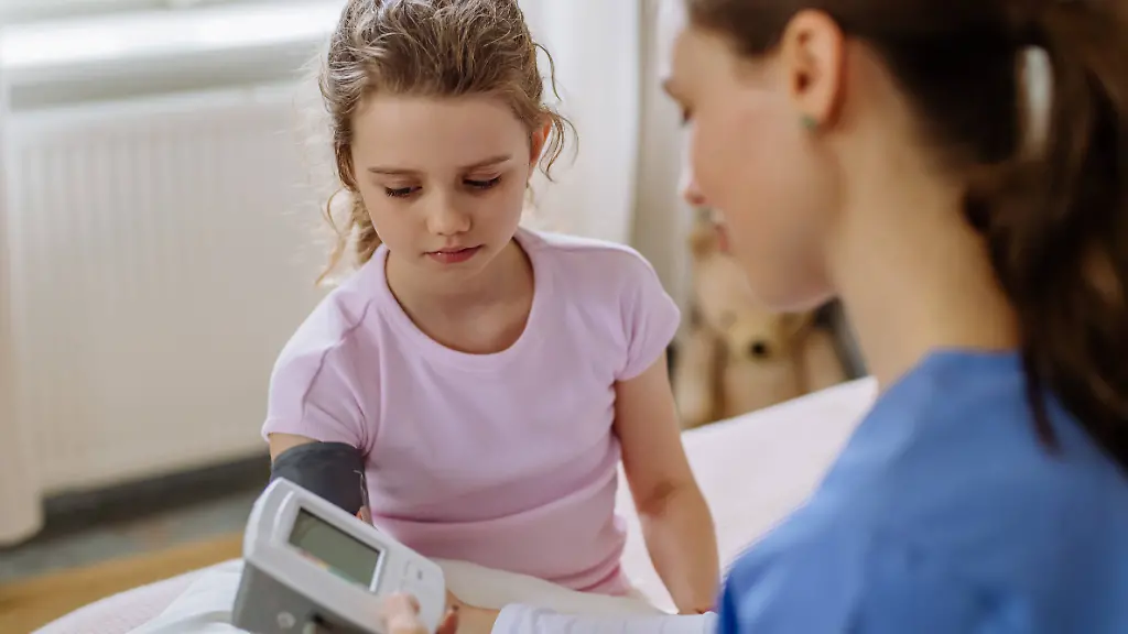 Young-doctor-taking-care-of-little-girl-in-hospital-room-Young-doctor-taking-care-of-little-girl-in-a-hospital-room