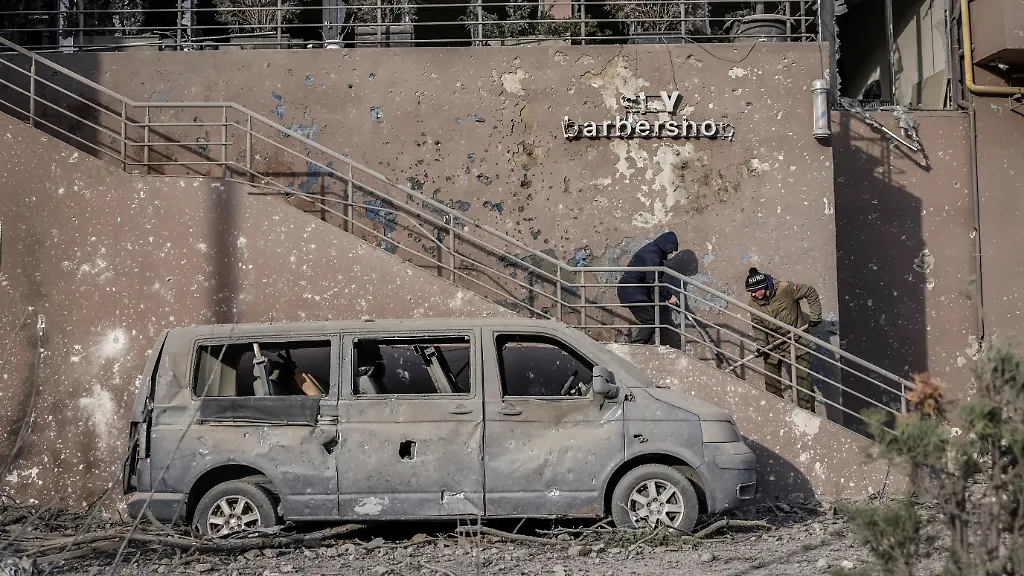 People-clean-up-debris-outside-of-a-residential-building-damaged-during-an-overnight-Russian-drone-and-missile-strike-amid-Russia-s-attack-on-Ukraine-in-Kyiv-Ukraine-November-14-2025