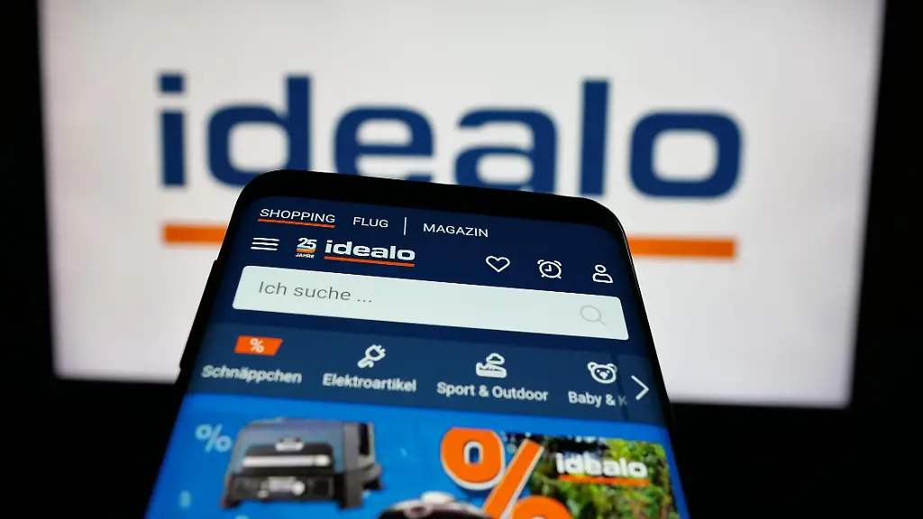 In-this-photo-illustration-a-mobile-phone-with-the-website-of-price-comparison-company-idealo-internet-GmbH-is-seen-on-screen-in-front-of-logo