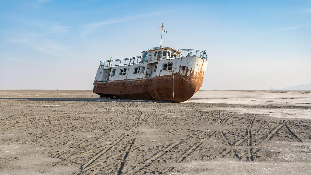 A-ship-rests-on-the-dry-bed-of-Urmia-Lake-West-Azerbaijan-province-Iran-on-October-13-2024-Urmia-Lake-at-its-greatest-extent-was-the-largest-lake-in-the-Middle-East-Due-to-the-general-drought-in-Iran-and-the-construction-of-numerous-dams-on-the-rivers-that-feed-it-Urmia-Lake-fully-dried-up-in-2025