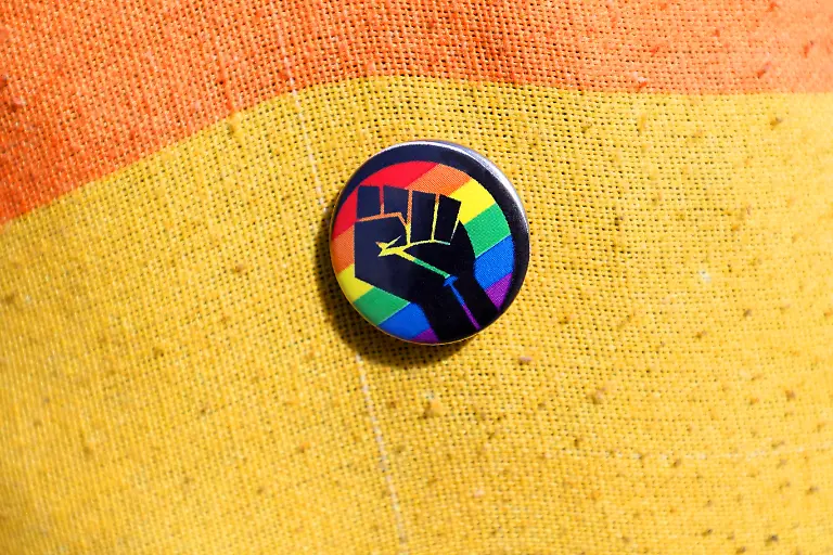 CHRISTOPHER-STREET-DAY-2024-Gotha-CSD-Am-31-August-2024-zieht-der-CSD-mit-ca-500-Teilnehmern-unter-dem-Motto-Thueringen-bleibt-bunt-in-Gotha-vom-Hauptbahnhof-aus-in-die-Innenstadt-Am-Endpunkt-der-Paradestrecke-gibt-es-eine-Abschlusskundgebung-mit-Redebeitraegen-und-Infostaenden-Der-CSD-Gotha-ist-eine-Demonstration-gegen-Diskriminierung-und-fuer-Gleichstellung-Akzeptanz-sowie-Toleranz-der-queeren-Community-Sticker-mit-Regenbogenfarben-Erhobene-Faust-CHRISTOPHER-STREET-DAY-2024-Gotha-CSD-On-August-31-2024-the-CSD-with-approx