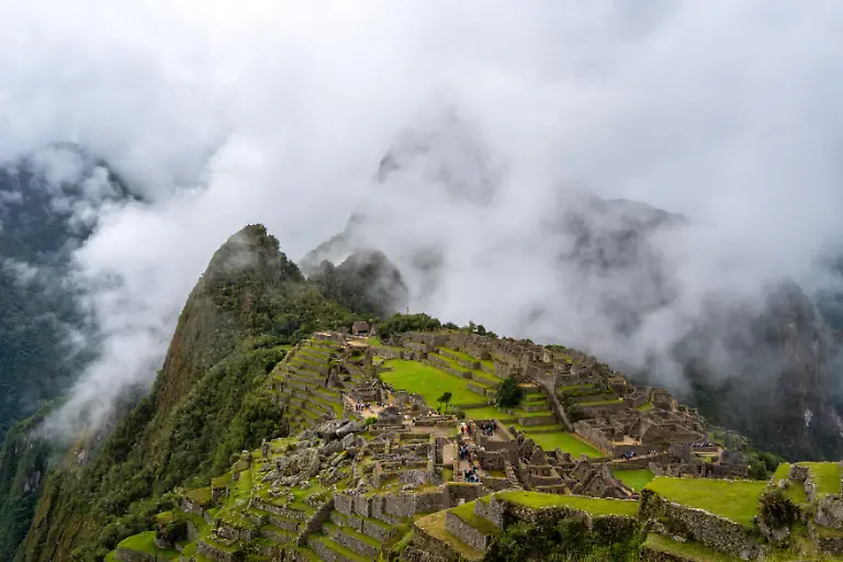 Machu-Picchu-the-famous-Inca-citadel-in-Peru-is-nestled-among-mist-covered-mountains-The-site-features-terraces-temples-and-stone-structures-showcasing-Inca-engineering-and-culture