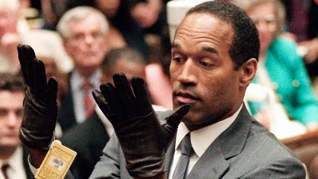 FILE-In-this-June-21-1995-file-photo-O-J-Simpson-holds-up-his-hands-before-the-jury-after-putting-on-a-new-pair-of-gloves-similar-to-the-infamous-bloody-gloves-during-his-double-murder-trial-in-Los-Angeles-During-Simpson-s-trial-a-prosecutor-famously-asks-him-to-put-on-a-pair-of-gloves-allegedly-worn-by-the-killer-The-gloves-appeared-to-be-too-tight-reinforcing-the-immortal-words-of-defense-attorney-Johnnie-Cochran-If-it-doesn-t-fit-you-must-acquit