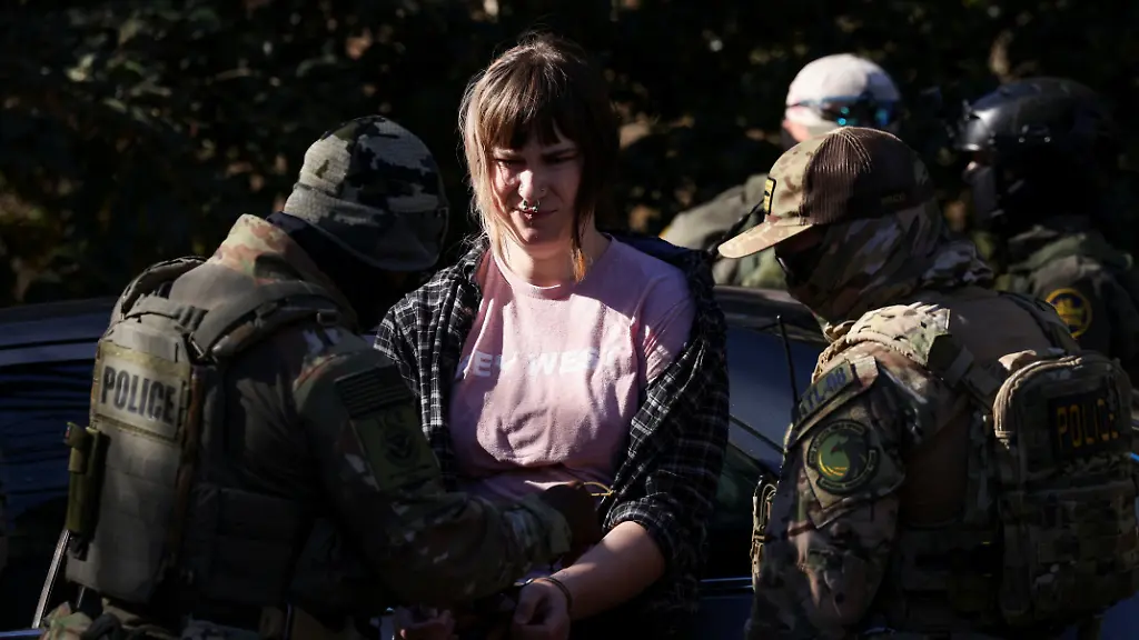 A-protestor-is-detained-as-members-of-the-U-S-Customs-and-Border-Protection-CBP-conduct-immigration-raids-on-the-streets-of-Charlotte-North-Carolina-U-S-November-17-2025