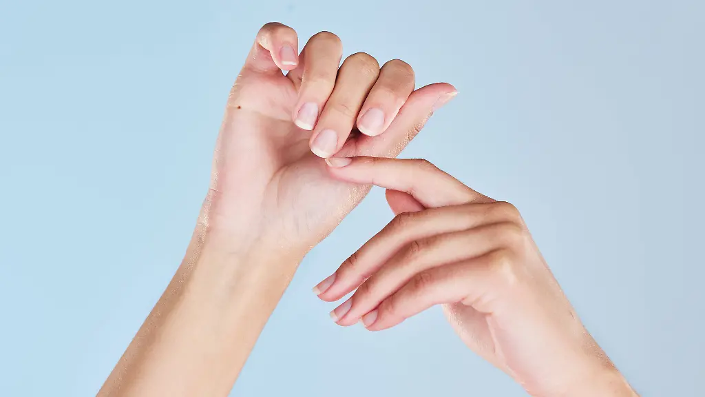 Manicure-nails-care-and-hands-of-woman-fresh-from-self-care-wellness-beauty-spa-or-nail-salon-on-studio-mockup-Nail-care-soft-skin-and-clean-palm-of-skincare-girl-isolated-on-blue-background-model-released-property-released-Copyright-xwww-peopleimages