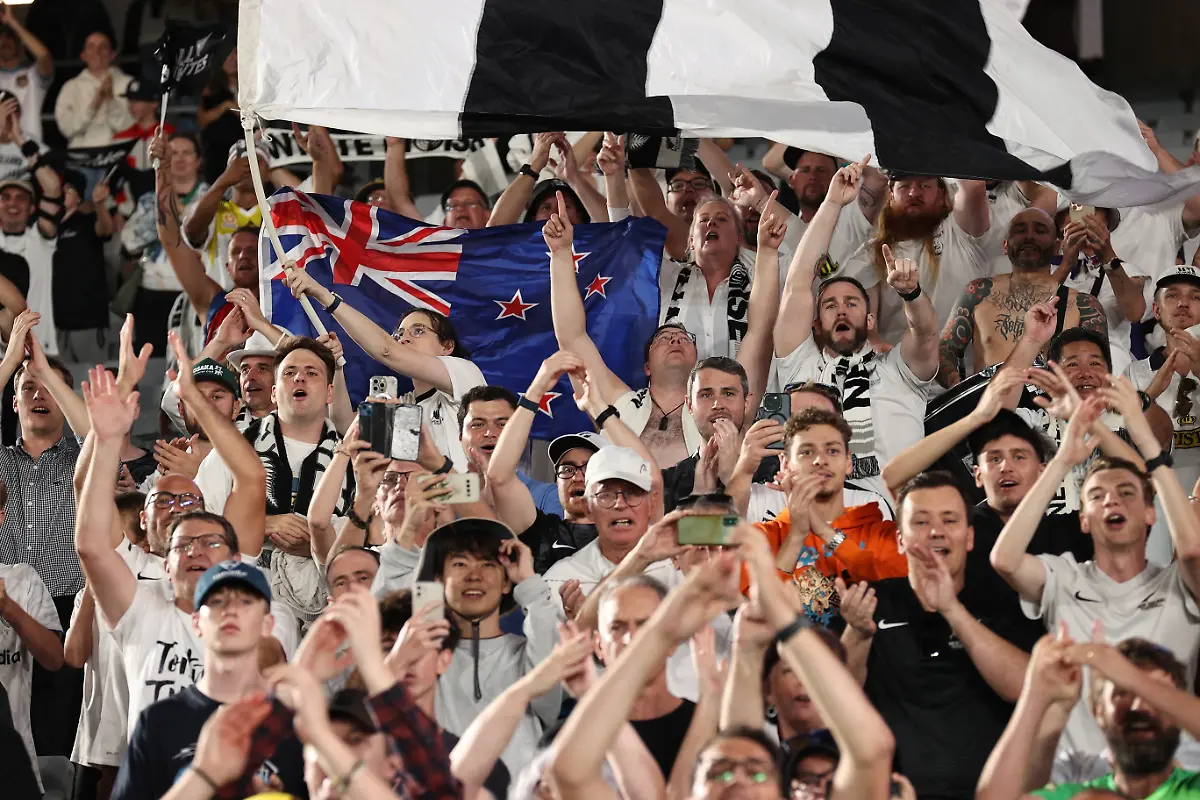 New-Zealand-supporters-celebrate-after-their-victory-during-the-FIFA-World-Cup-2026-Oceania-qualifiers-group-final-football-match-between-New-Zealand-and-New-Caledonia-at-Eden-Park-Stadium-in-Auckland-on-March-24-2025