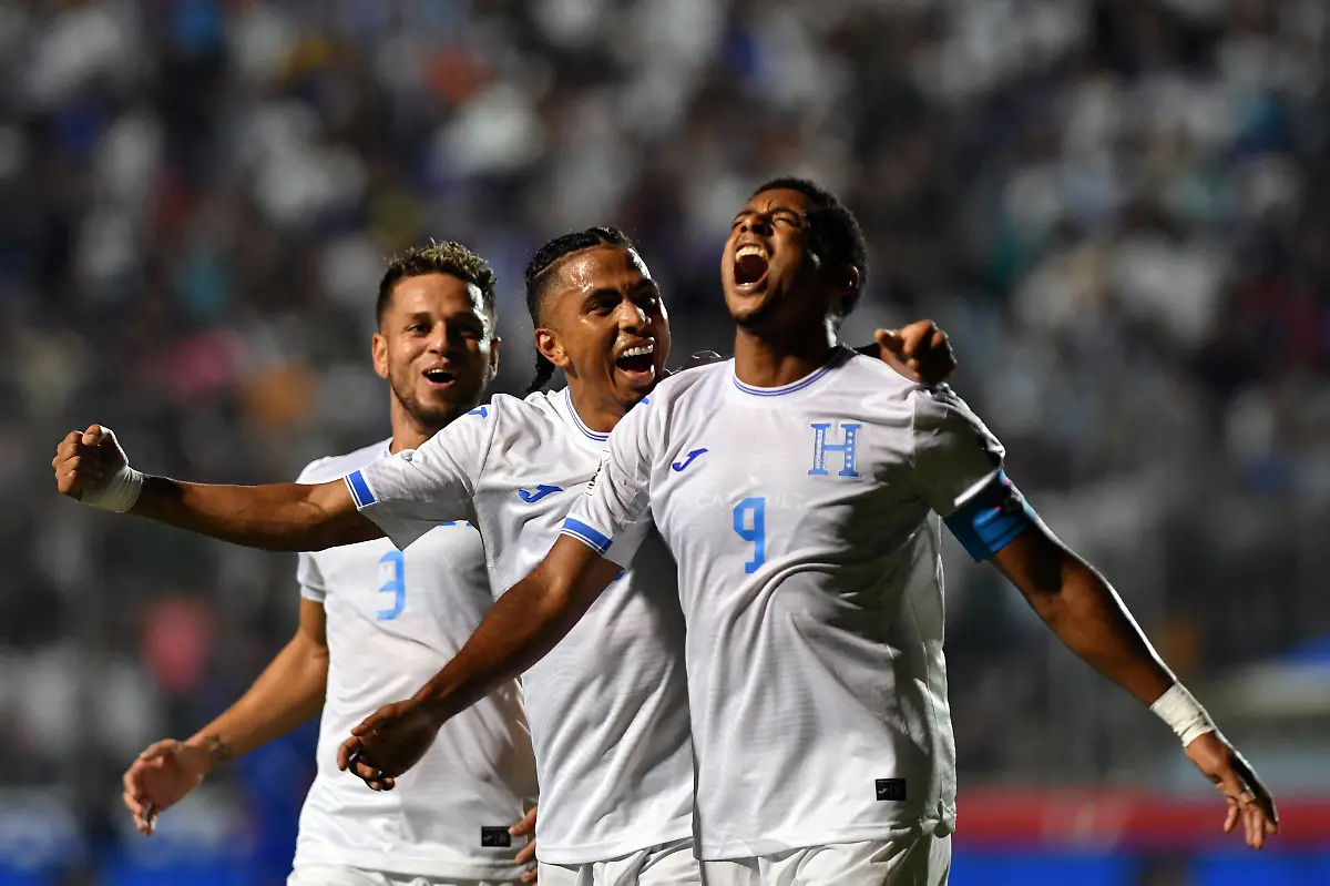 Honduras-forward-09-Anthony-Lozano-R-celebrates-with-teammates-midfielder-06-Rigoberto-Rivas-C-and-defender-03-Raul-Marcelo-Santos-after-scoring-his-team-s-second-goal-during-the-2026-FIFA-World-Cup-Concacaf-qualifier-football-match-between-Honduras-and-Haiti-at-the-Chelato-Ucles-National-Stadium-in-Tegucigalpa-on-October-13-2025-Photo-by-Orlando-SIERRA-AFP-The-erroneous-mention-s-appearing-in-the-metadata-of-this-photo-by-Orlando-SIERRA-has-been-modified-in-AFP-systems-in-the-following-manner-midfielder-06-Rigoberto-Rivas-instead-of-defender-06-Cristopher-Melendez-Please-immediately-remove-the-erroneous-mention-s-from-all-your-online-services-and-delete-it-them-from-your-servers-If-you-have-been-authorized-by-AFP-to-distribute-it-them-to-third-parties-please-ensure-that-the-same-actions-are-carried-out-by-them-Failure-to-promptly-comply-with-these-instructions-will-entail-liability-on-your-part-for-any-continued-or-post-notification-usage-Therefore-we-thank-you-very-much-for-all-your-attention-and-prompt-action-We-are-sorry-for-the-inconvenience-this-notification-may-cause-and-remain-at-your-disposal-for-any-further-information-you-may-require