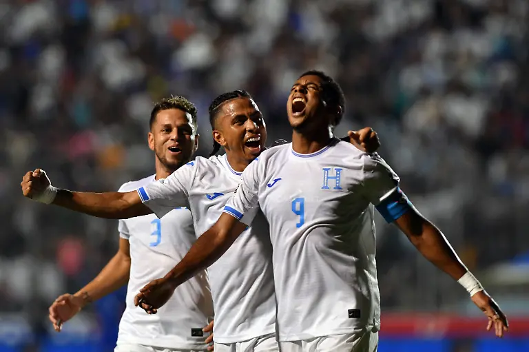 Honduras-forward-09-Anthony-Lozano-R-celebrates-with-teammates-midfielder-06-Rigoberto-Rivas-C-and-defender-03-Raul-Marcelo-Santos-after-scoring-his-team-s-second-goal-during-the-2026-FIFA-World-Cup-Concacaf-qualifier-football-match-between-Honduras-and-Haiti-at-the-Chelato-Ucles-National-Stadium-in-Tegucigalpa-on-October-13-2025-Photo-by-Orlando-SIERRA-AFP-The-erroneous-mention-s-appearing-in-the-metadata-of-this-photo-by-Orlando-SIERRA-has-been-modified-in-AFP-systems-in-the-following-manner-midfielder-06-Rigoberto-Rivas-instead-of-defender-06-Cristopher-Melendez-Please-immediately-remove-the-erroneous-mention-s-from-all-your-online-services-and-delete-it-them-from-your-servers-If-you-have-been-authorized-by-AFP-to-distribute-it-them-to-third-parties-please-ensure-that-the-same-actions-are-carried-out-by-them-Failure-to-promptly-comply-with-these-instructions-will-entail-liability-on-your-part-for-any-continued-or-post-notification-usage-Therefore-we-thank-you-very-much-for-all-your-attention-and-prompt-action-We-are-sorry-for-the-inconvenience-this-notification-may-cause-and-remain-at-your-disposal-for-any-further-information-you-may-require