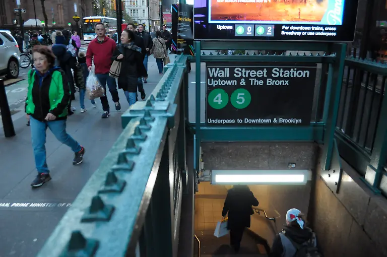 November-4-2025-New-York-United-States-People-walk-past-the-Wall-Street-subway-station-in-the-Financial-District-in-Manhattan-New-York-City