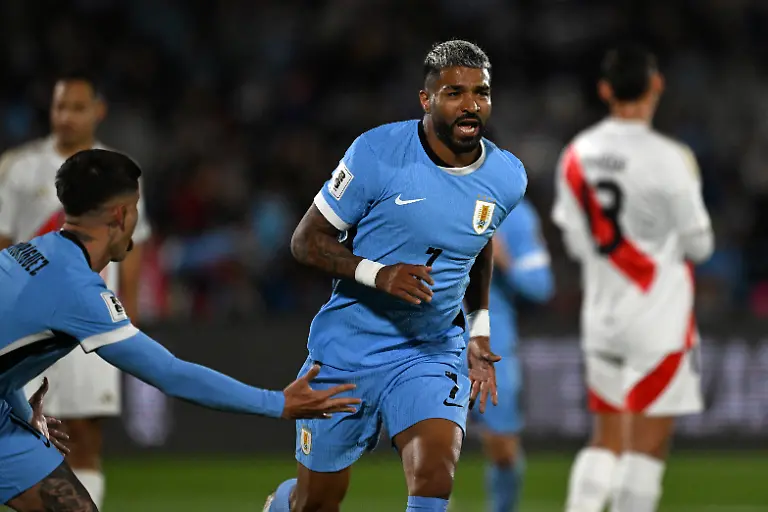 Uruguay-s-forward-07-Rodrigo-Aguirre-celebrates-with-Uruguay-s-defender-18-Brian-Rodriguez-after-scoring-his-team-s-first-goal-during-the-2026-FIFA-World-Cup-South-American-qualifiers-football-match-between-Uruguay-and-Peru-at-the-Centenario-stadium-in-Montevideo-on-September-4-2025