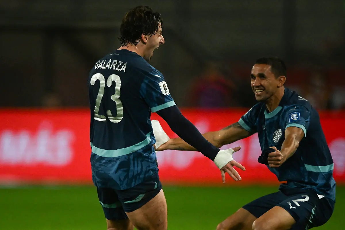 Paraguay-s-midfielder-23-Matias-Galarza-celebrates-with-his-teammate-Paraguay-s-defender-02-Gustavo-Velazquez-after-scoring-his-team-s-first-goal-during-the-2026-FIFA-World-Cup-South-American-qualifiers-football-match-between-Peru-and-Paraguay-at-the-Nacional-stadium-in-Lima-on-September-9-2025