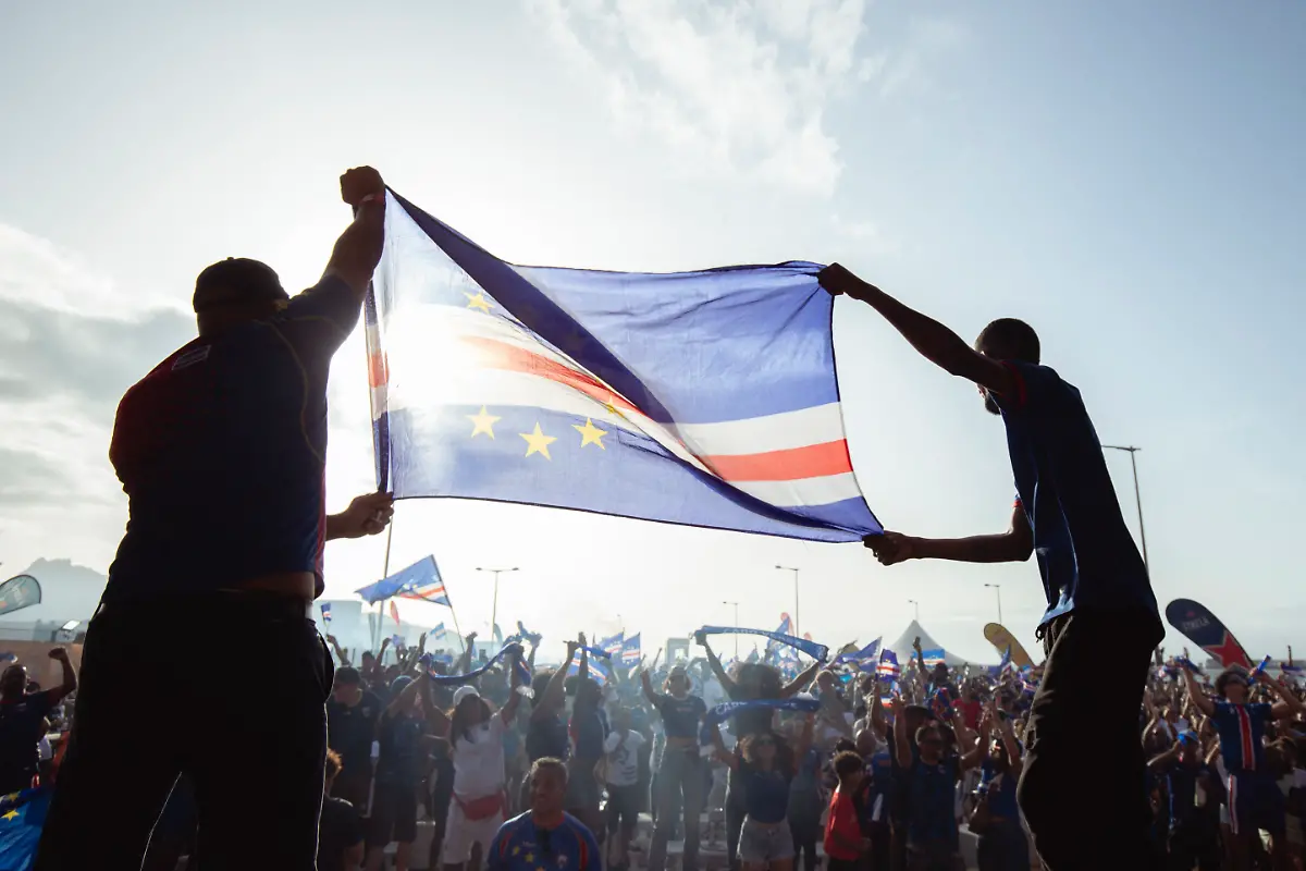 Supporters-celebrate-Cape-Verdes-victory-against-Eswatini-during-the-FIFA-World-Cup-2026-Africa-qualifiers-group-D-match-at-a-fan-zone-in-Sao-Vicente-Cape-Verde-on-October-13-2025-A-carnival-like-atmosphere-erupted-in-the-streets-of-Cape-Verde-on-Monday-after-the-tiny-archipelago-nation-qualified-for-the-first-time-ever-for-the-World-Cup-Located-off-the-coast-of-Senegal-it-is-the-country-with-the-smallest-population-to-represent-Africa-in-the-global-showpiece-with-just-550-000-inhabitants